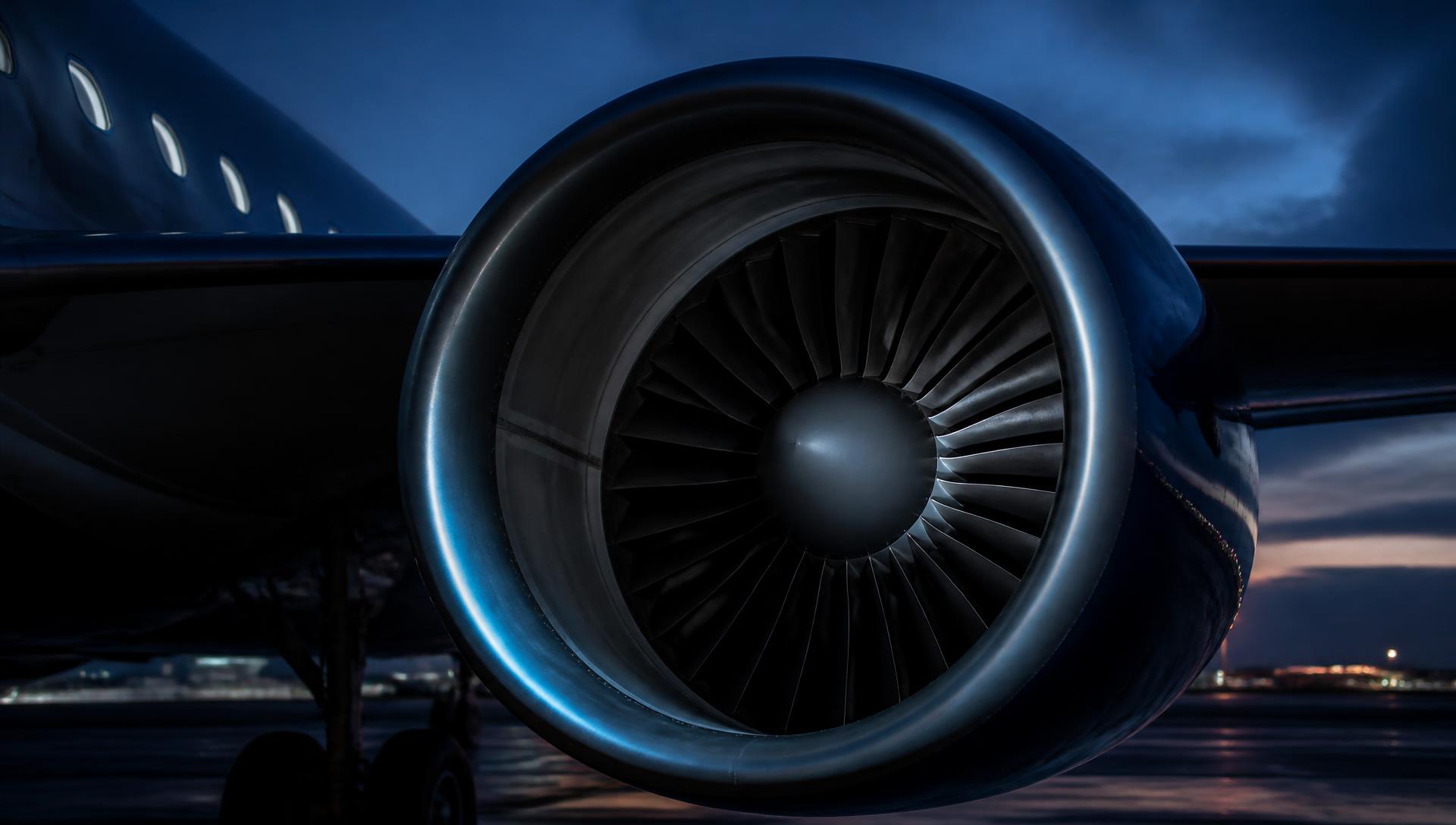 Close-up of a commercial airliner turbofan engine on the ramp at dusk